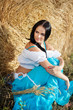 portrait of a girl next to haystack