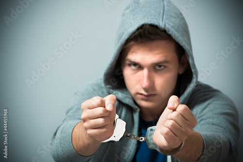 Photo: Arrested teenager with handcuffs on his hands Arrested teenager with handcuffs on his hands