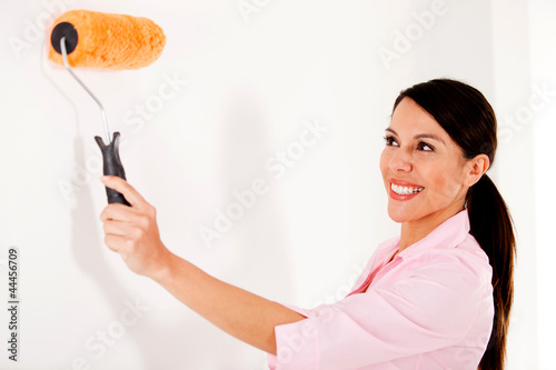Photo: Woman painting house Woman painting house