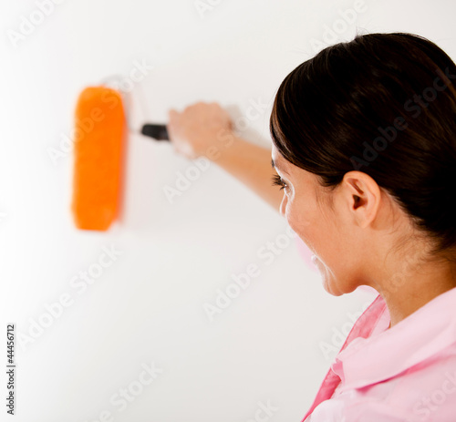 Photo: Woman painting a wall Woman painting a wall