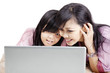 Photo: Happy mother and daughter with laptop Happy mother and daughter with laptop