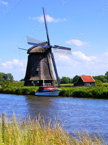 Photo: Dutch windmill along a canal near Alkmaar, Netherlands Dutch windmill along a canal near Alkmaar, Netherlands