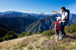 Man and young boy standing in a mountain meadow