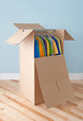 Wardrobe box with colorful clothing, ready for moving