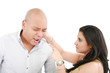 Beautiful Caucasian woman twisting boyfriend's ear while he scre