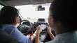 Video: Two businesswomen using tablet computer in a car, rear view Two businesswomen using tablet computer in a car, rear view