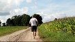 Video: Man running along the corn field in summer Man running along the corn field in summer