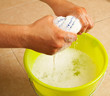 Hands wringing the water out of a mop cloth