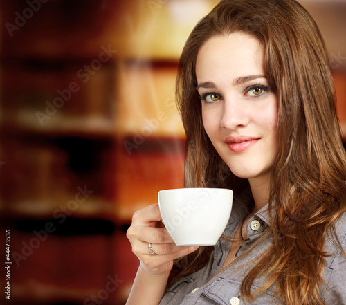 Photo: Young Woman Enjoying a Hot Beverage Young Woman Enjoying a Hot Beverage