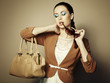 Photo: Portrait of beautiful young woman with a leather bag Portrait of beautiful young woman with a leather bag