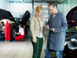 Photo: Car mechanic and customer looking at a quotation Car mechanic and customer looking at a quotation