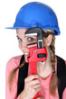 Funny female laborer with wrench