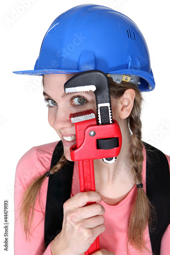 Photo: Funny female laborer with wrench Funny female laborer with wrench