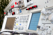 analog and digital oscilloscope in the foreground