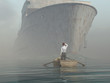 Illustration: man in boat looking on approaching vessel man in boat looking on approaching vessel