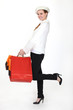 Woman in hat holding shopping bags