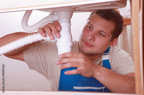 Photo: portrait of a young plumber portrait of a young plumber