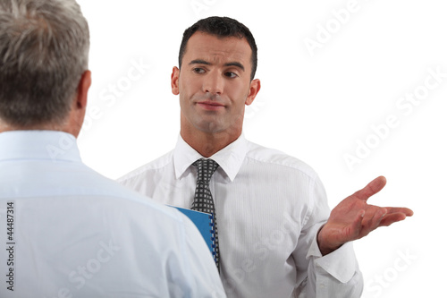 Photo: Businessman explaining point to colleague Businessman explaining point to colleague