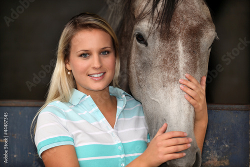 Photo: Woman stroking a horse Woman stroking a horse
