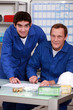 Two factory workers checking inventory
