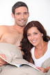 Couple reading a book in bed
