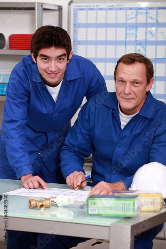 Photo: Two factory workers checking inventory Two factory workers checking inventory
