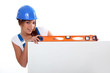 pretty worker girl showing her tool