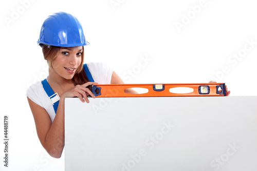 Photo: pretty worker girl showing her tool pretty worker girl showing her tool