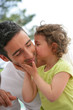 little girl kissing her father