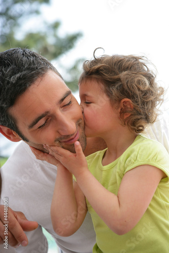 Photo: little girl kissing her father little girl kissing her father