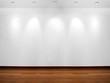 Empty white wall with 3 spot lights and wooden floor