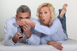 Woman trying to block her husband's view