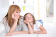 Foto: Mother and daughter laying down at home Mother and daughter laying down at home