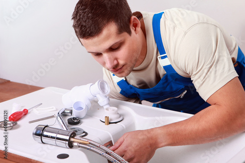Photo: Plumbers install faucet Plumbers install faucet