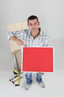 Carpenter pointing to a red poster
