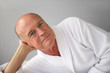 Elderly man lying in his bathrobe