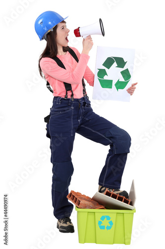 Photo: Eco-friendly tradeswoman yelling into a megaphone Eco-friendly tradeswoman yelling into a megaphone