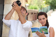 Couple of tourists with camera and guide book