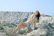 beautiful girl on stone coast near lake