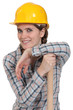 portrait of craftswoman with arm resting on hammer
