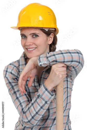 Photo: portrait of craftswoman with arm resting on hammer portrait of craftswoman with arm resting on hammer