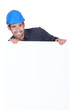 Manual worker stood with advertisement board