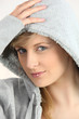 blue-eyed blonde wearing with hand on hood