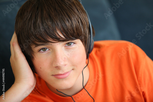 Photo: Teenager listening to music on headphones Teenager listening to music on headphones
