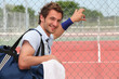 Photo: Tennis player leaning against fence Tennis player leaning against fence