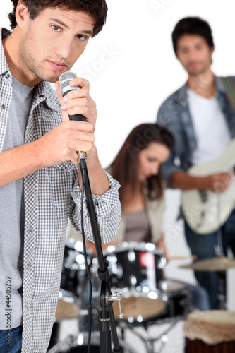 Photo: Young man singing in a band Young man singing in a band