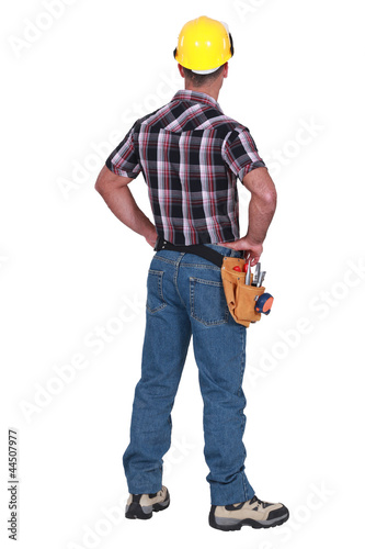Photo: Laborer standing on white background, back-view Laborer standing on white background, back-view