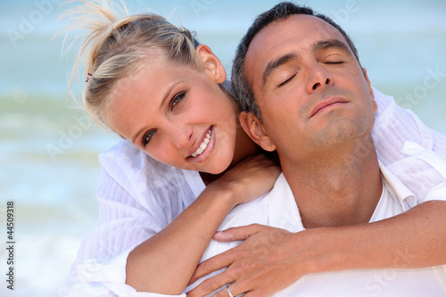 Photo: Loving couple hugging on the beach Loving couple hugging on the beach