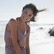 Portrait of smiling woman on sunny beach