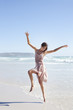 Carefree woman dancing on sunny beach